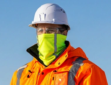 A construction worker wears a reflective custom tube bandana while working.